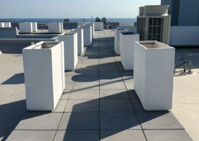 Commercial masonry project, modern rooftop stone patio and walkway overlooking the city skyline.