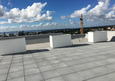 Commercial masonry project, modern rooftop stone patio and walkway overlooking the city skyline.