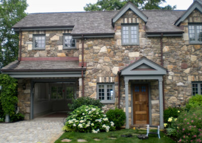 Modern home renovation, expertly installed mosaic natural stone veneer on residential exterior.