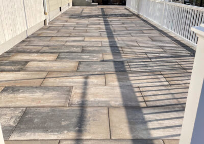 Contemporary residential stone deck renovation with minimalist natural stone pavers.